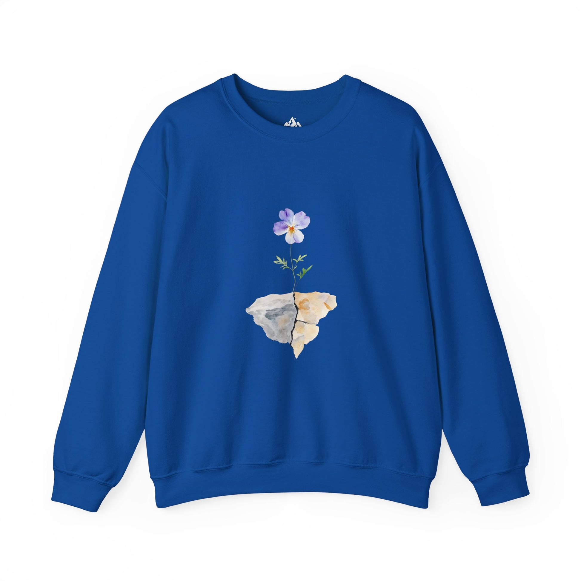 Blue sweatshirt featuring a watercolor flower growing from cracked rocks, faith-inspired apparel