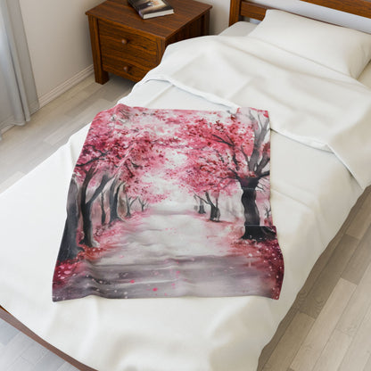 Cherry Blossom Path Velveteen Plush Blanket — blanket displayed on a bed