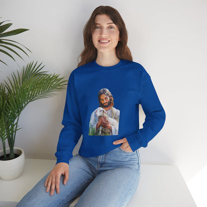 Woman in blue sweatshirt with Jesus holding a lamb graphic, sitting indoors by a plant