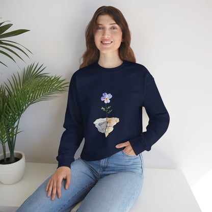 Woman in navy sweatshirt featuring a purple flower and stone graphic, casual home decor style