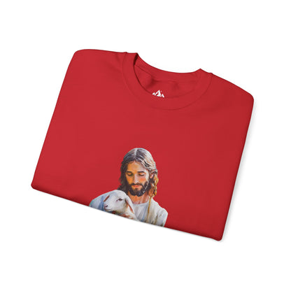 Red Christian sweatshirt with Jesus holding a lamb graphic, folded on white background