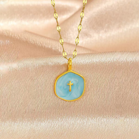 Blue cross pendant on a fine gold-tone chain