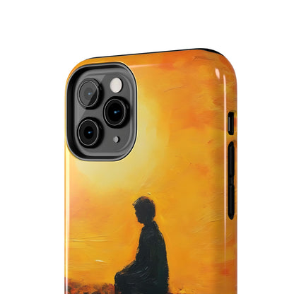 Phone case with silhouette of person meditating against a yellow sunrise background