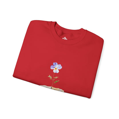 Red Christian sweatshirt with blue flower and cross design, folded on white background