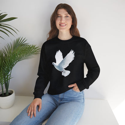 Woman wearing black Christian sweatshirt with white dove graphic, sitting by plant