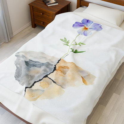 Watercolor flower growing from cracked stone on white bedspread, faith-inspired bedroom decor