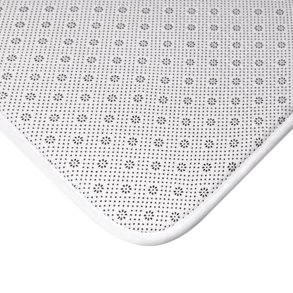 Close-up of anti-slip floral patterned white bath mat corner