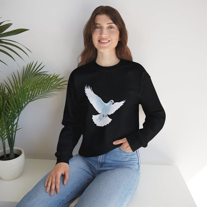 Woman wearing black sweatshirt with white dove graphic, sitting by green potted plant