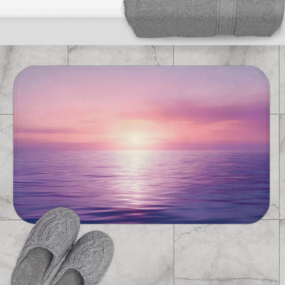 Serene ocean sunset bath mat with pink and purple sky on marble bathroom floor, cozy slippers nearby