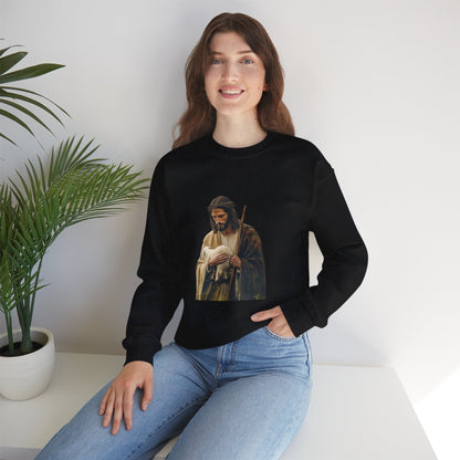 Woman wearing black Christian sweatshirt with Jesus and lamb graphic, sitting by potted plant