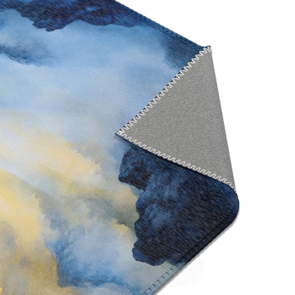 Corner of a soft blanket with blue and yellow watercolor design and visible stitching