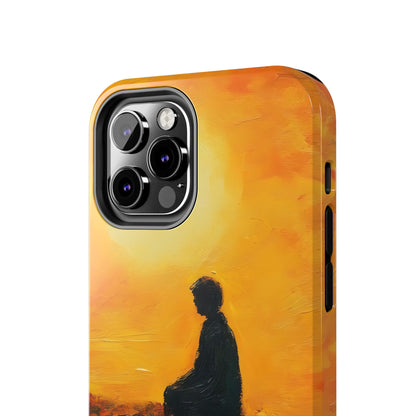 Phone case with silhouette of person meditating at sunrise in warm orange tones