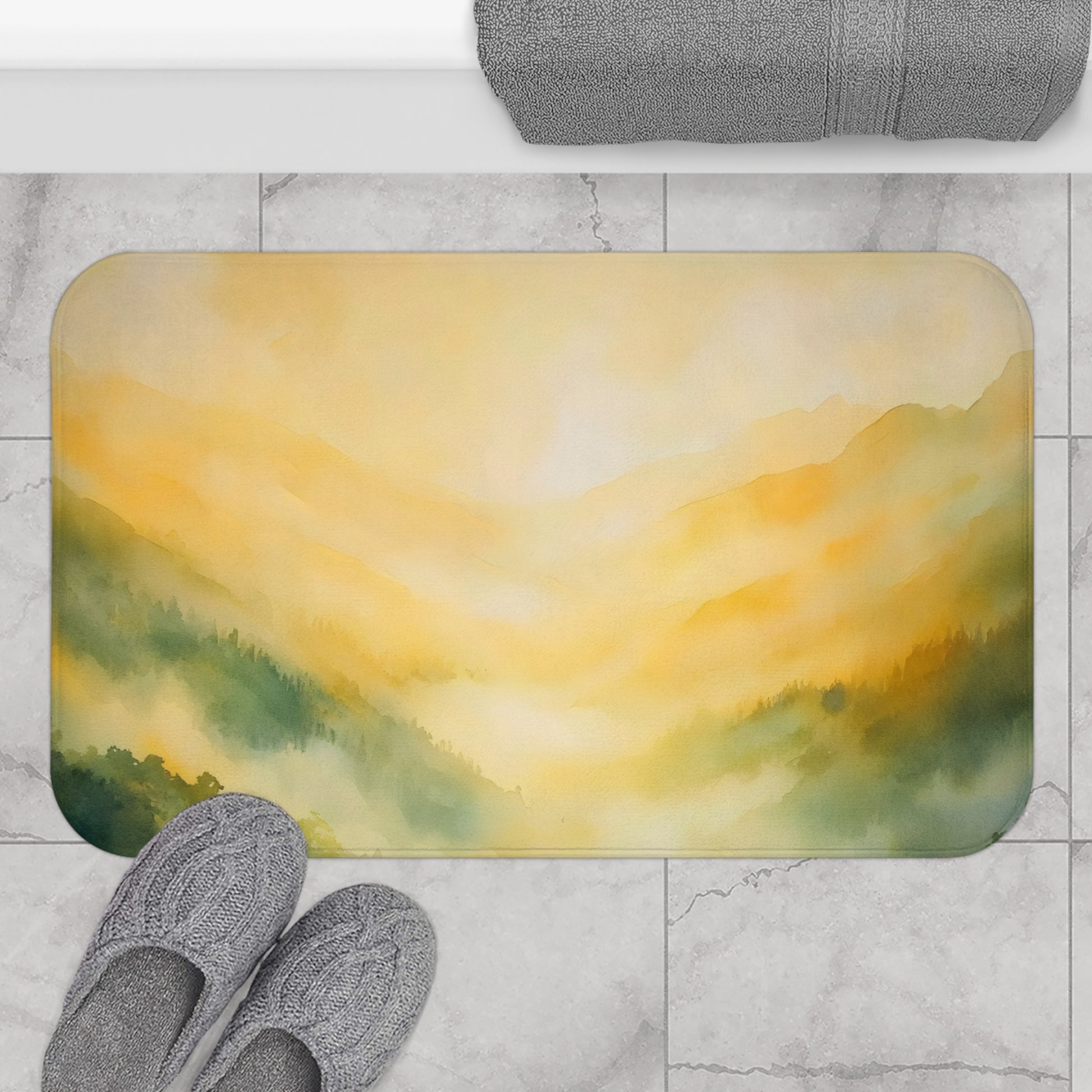 Yellow and green mountain landscape bath mat on marble floor with cozy gray slippers