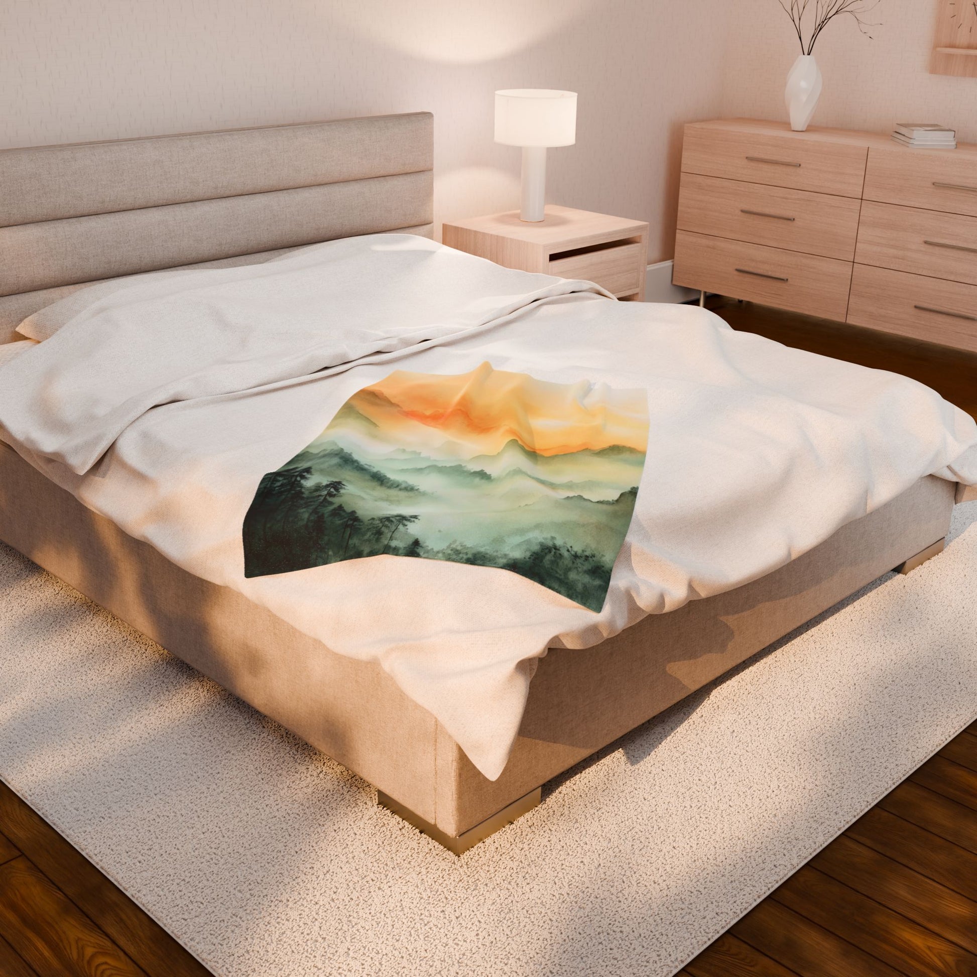Cozy bedroom with a beige bedspread featuring a serene mountain sunrise watercolor print