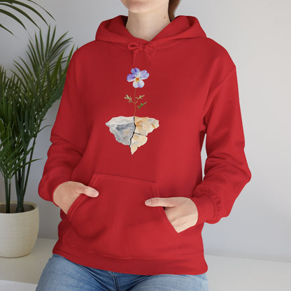 Red hoodie with cracked stone and blooming flower graphic, worn by woman indoors