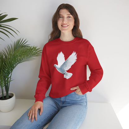 Woman in red sweatshirt with white dove print, sitting by a potted plant, faith-inspired apparel