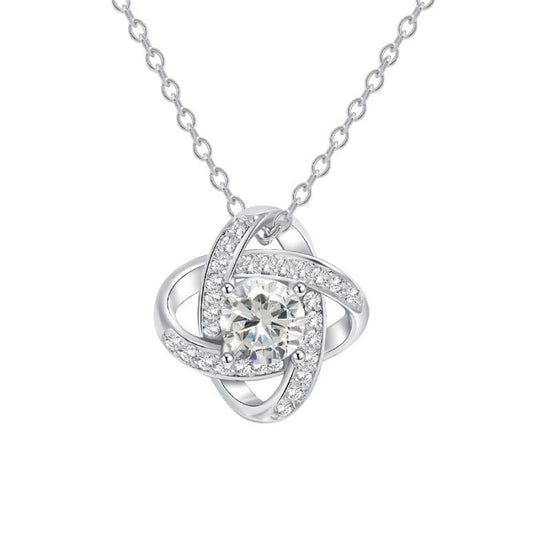 Silver-tone crystal knot pendant and delicate chain isolated on white