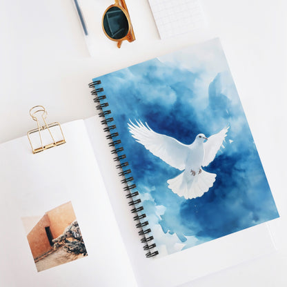 Spiral notebook with white dove on blue watercolor cover, faith-inspired stationery on desk
