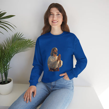 Woman wearing blue Christian sweatshirt with praying Jesus illustration, sitting indoors