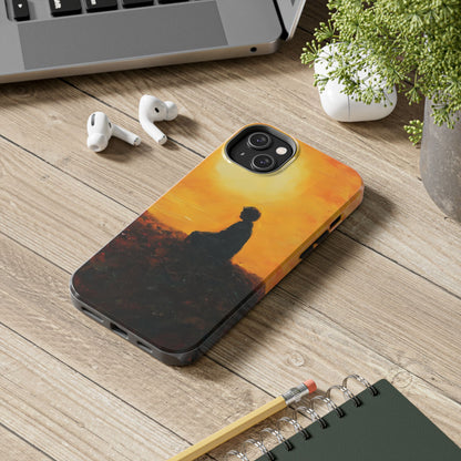 Phone case with silhouette of person meditating at sunset, spiritual art design on desk