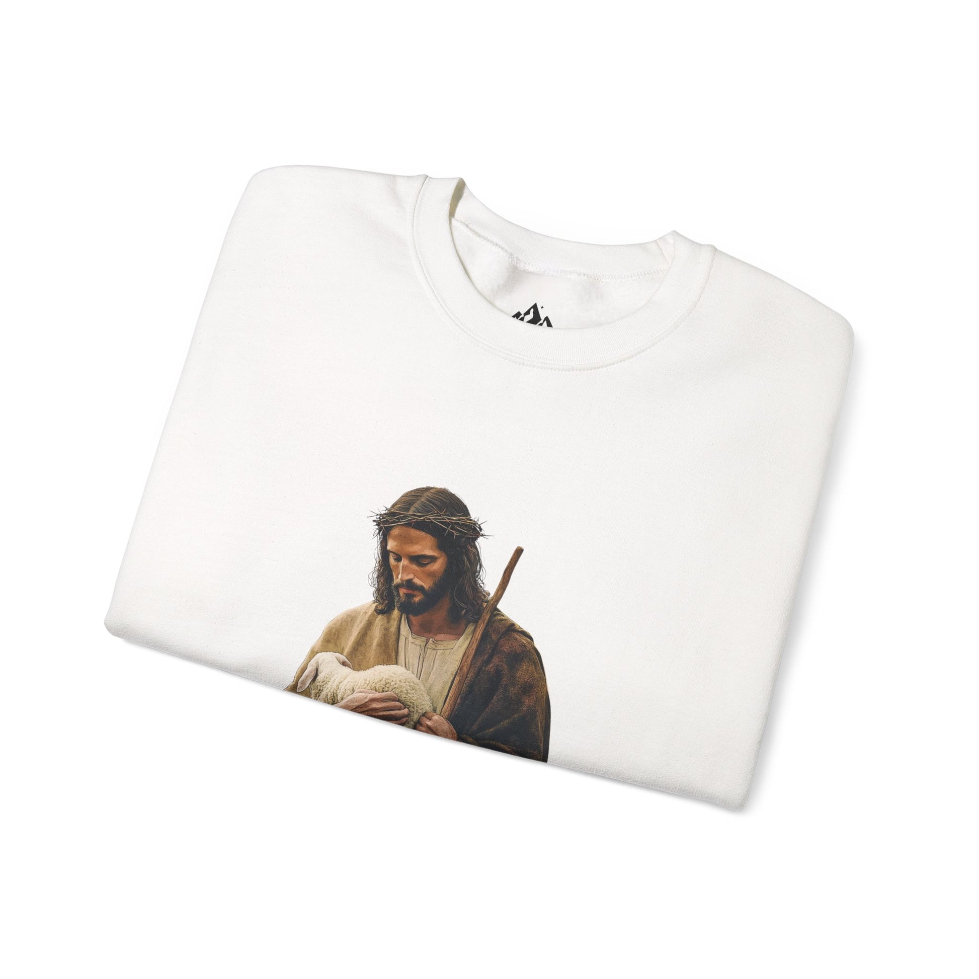Folded white Christian sweatshirt featuring artwork of Jesus with a lamb and staff