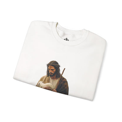 Folded white Christian sweatshirt featuring artwork of Jesus with a lamb and staff