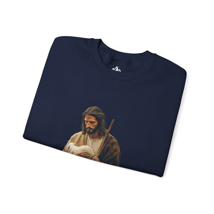Navy blue Christian sweatshirt with shepherd holding lamb graphic, faith apparel flat lay