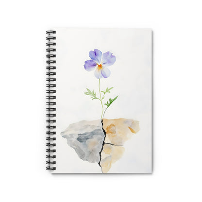 Watercolor purple flower growing from cracked rock on spiral notebook cover