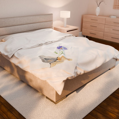 Minimalist bedroom with beige bedding featuring a floral and rock Christian-themed blanket
