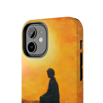 Phone case with silhouette of person meditating against a warm yellow sunset background