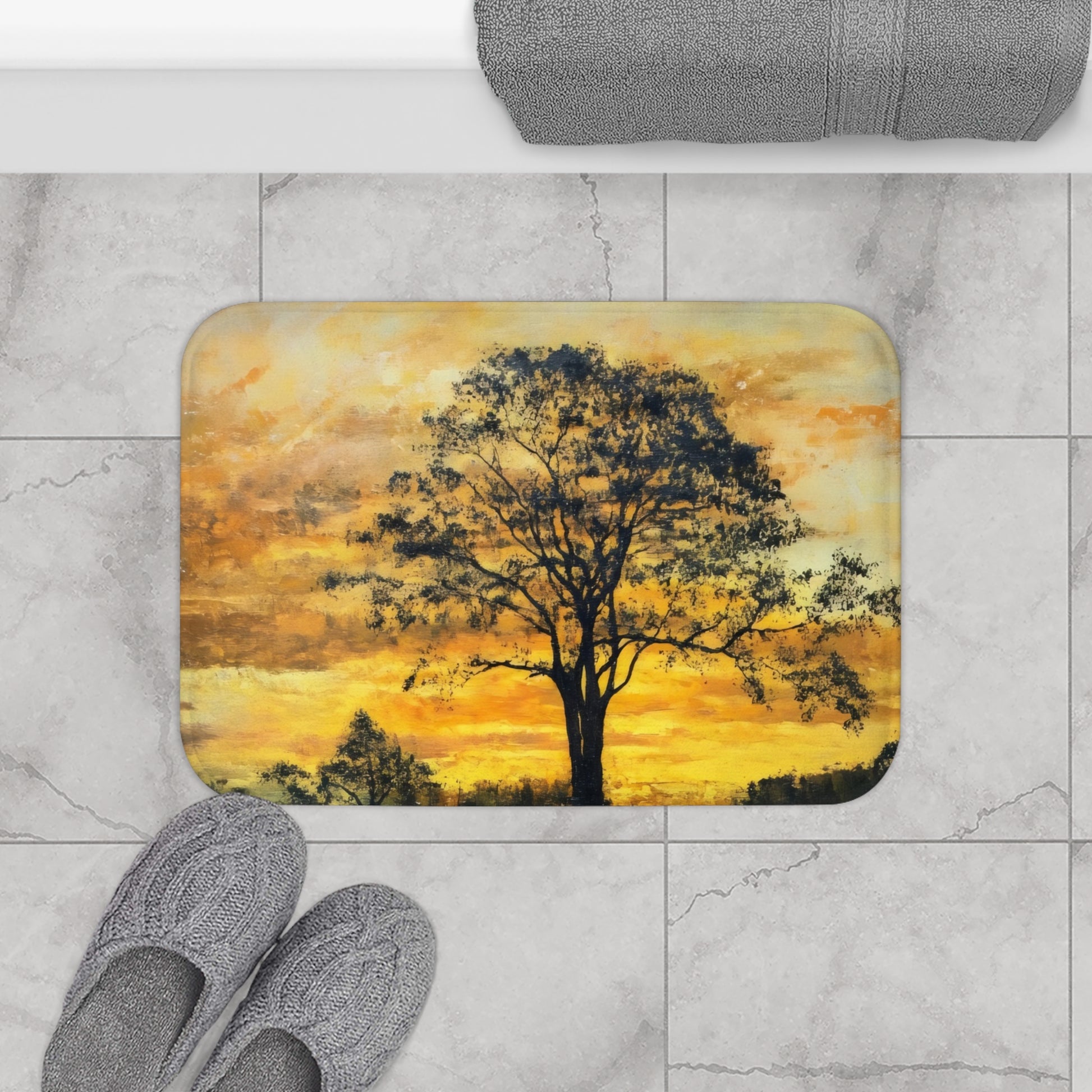 Bathroom mat with serene tree and sunset design on marble tile floor, cozy slippers and towel