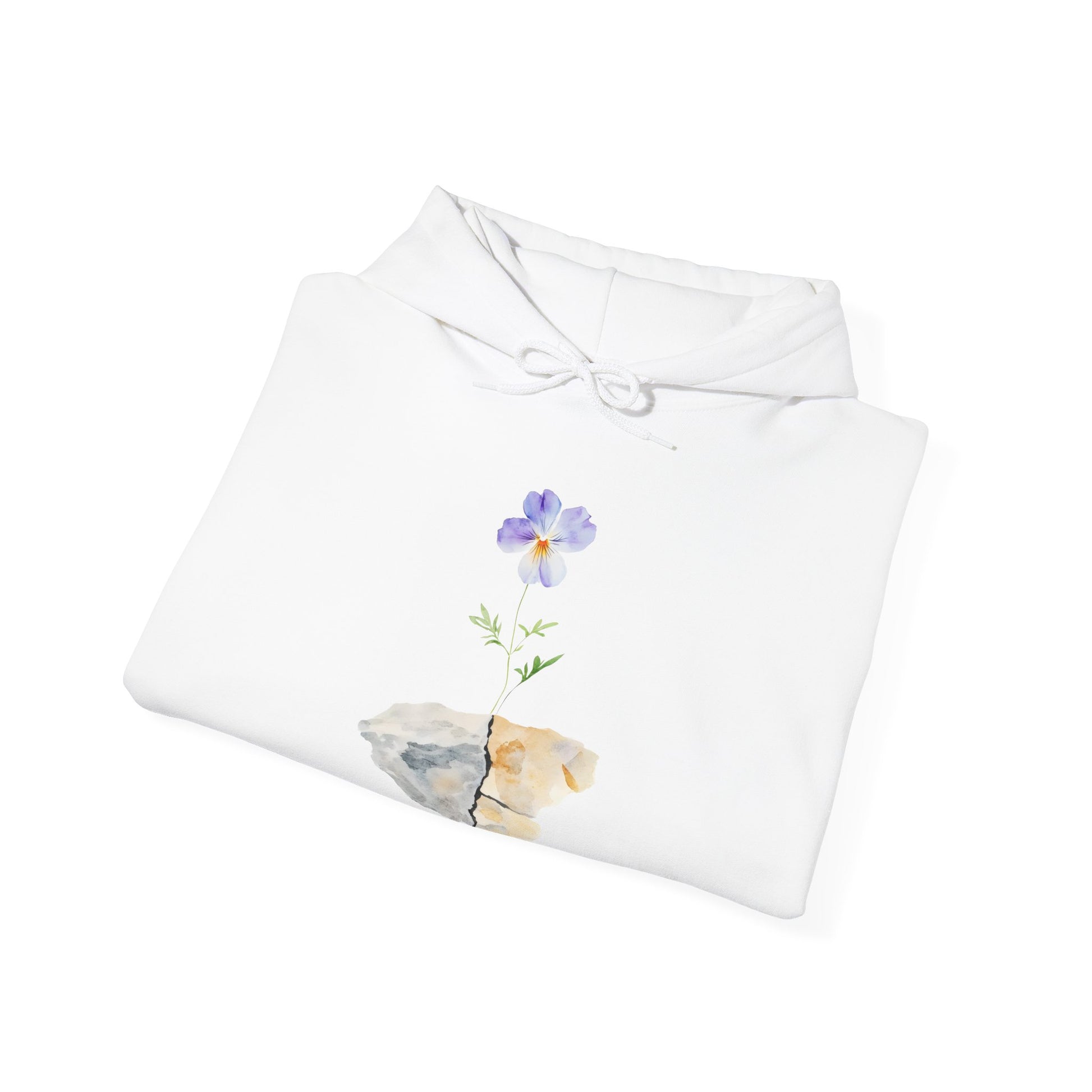 White hoodie with watercolor purple flower growing from cracked stone design, folded on white background
