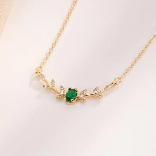 Green crystal leaf pendant on a fine gold-tone chain