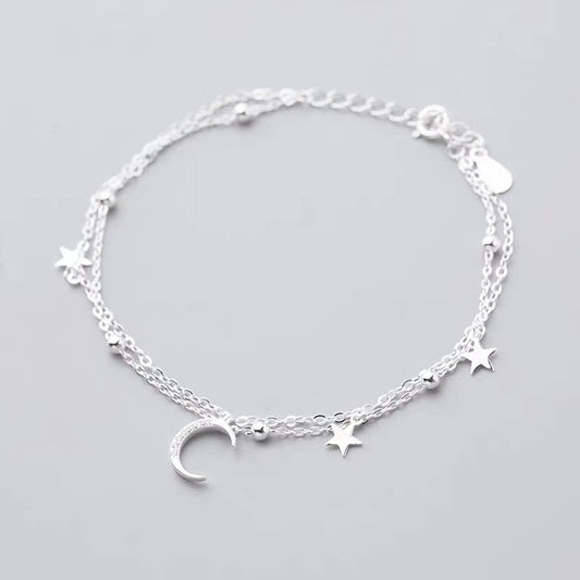 Silver-tone star and moon bracelet arranged in a circle